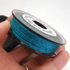 Close-up view of 0.85mm teal braided jade thread on a spool for DIY jewelry making