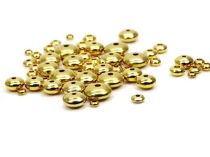 Nahaufnahme von goldenen Messing-Abstandshalterperlen in verschiedenen Größen.