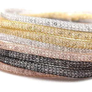 Detailed macro view of multi-color mesh tube necklaces filled with sparkling crystals