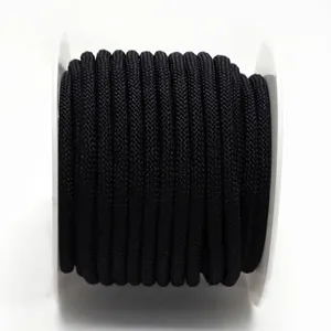Close-up detail of black 3mm braided cord on white spool for DIY necklace making