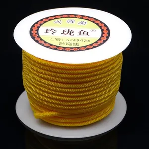 Detailed macro shot of golden yellow 3mm braided cord on a spool for DIY jewelry crafts