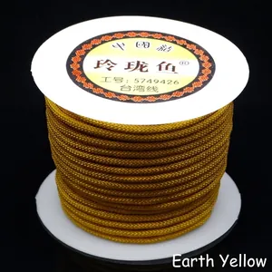 Macro detail of mustard yellow 3mm braided nylon cord spool for DIY jewelry making