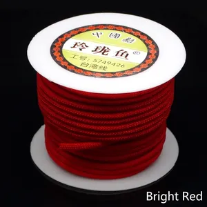 Close-up detail of 3mm bright red braided cord on a white spool for DIY jewelry projects.