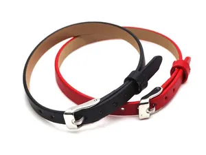 Close-up detail of slim red and black leather wristbands with adjustable silver buckles