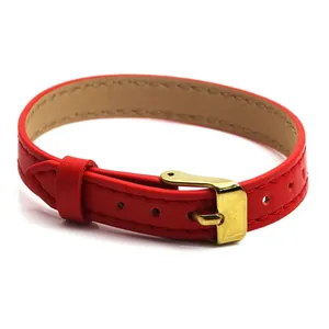 Close-up detail of a red leather watch-style bracelet with a polished gold buckle