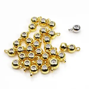 Macro detail of 14k gold plated copper positioning beads with white silicone inner rings.