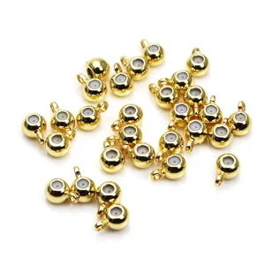 Close-up detail of 14k gold plated positioning beads with white silicone inner ring
