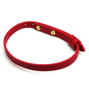 Minimalist fashion red leather wrap bracelet featuring elegant gold screw-style studs.