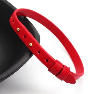 Minimalist slim red leather buckle bracelet featuring small decorative gold studs