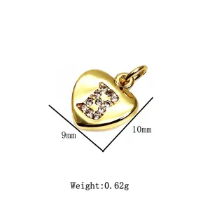 Macro detail of gold heart charm with micro-pave zirconia letter B and 10mm size