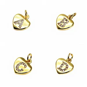 Detail of gold heart pendants with micro-pave zircon letters A, B, C, and D