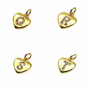 Detailed view of micro-pave cubic zirconia gold heart initial charms Q R S T for DIY