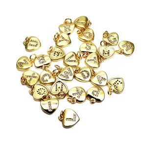 Detail shot of 26 gold heart alphabet charms with micro-pave CZ stones for DIY jewelry
