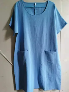 Detailed view of a blue cotton linen summer dress featuring a round neck and side pockets