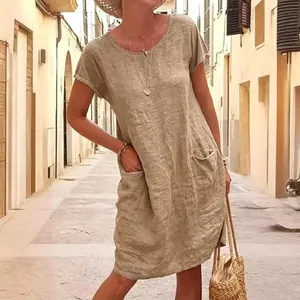 Detail view showing the loose fit and pocket design of a washed cotton linen dress