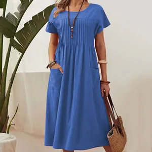 Detail of a blue cotton linen maxi dress featuring a pleated front and practical pockets.