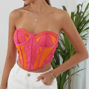 Close-up view of the intricate pink lace patterns and underwire of this corset top.