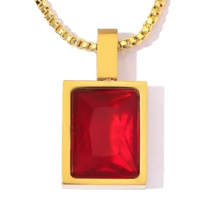 Close-up of a gold stainless steel necklace featuring a rectangular red zircon stone pendant.