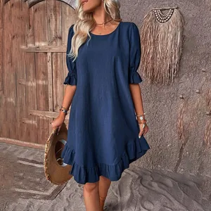 Detail view of a vintage navy blue cotton linen dress with ruffle sleeves and hem