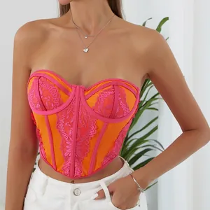 Close-up of vibrant orange and pink lace bustier top featuring a corset fishbone design