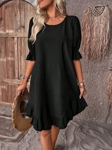 Vintage black cotton-linen dress featuring ruffled cuffs and hem with a loose round neck fit
