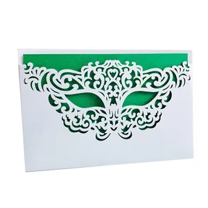 Close-up detail of laser-cut masquerade mask party invitation card with green insert