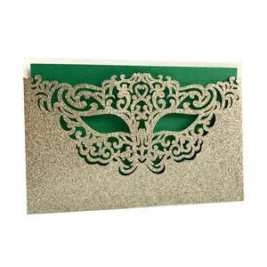 Detailed view of laser-cut glitter paper party invitation featuring a mask design