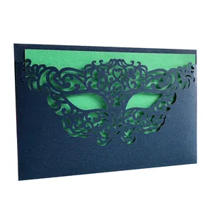 Detail view of laser-cut masquerade mask pattern on glitter paper invitation card