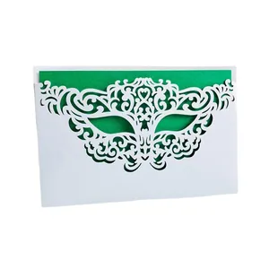 Elegant white laser-cut masquerade mask invitation card featuring a green insert