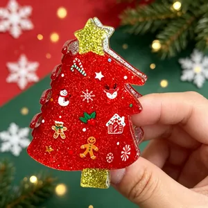 Detailed view of a red glittery Christmas tree hair claw clip with festive icons