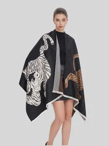 Female model wearing an oversized black jacquard shawl with tiger and leopard prints