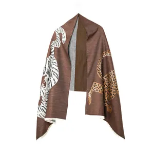 Detail of a brown vintage jacquard scarf featuring tiger and leopard animal print patterns.