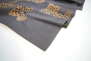 Close-up of grey jacquard scarf with brown leopard print and soft texture