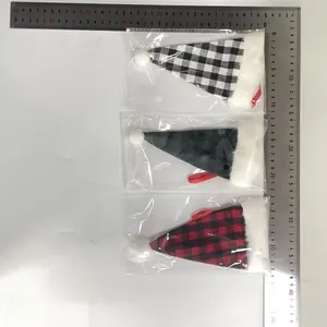 Detailed view of Christmas plaid hat-shaped cutlery bags with a size ruler reference