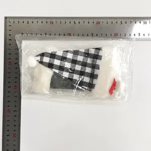 Detailed view of three black and white checkered Christmas cutlery holders in a pack