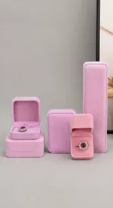 Display of various rounded pink velvet jewelry boxes for rings necklaces and bracelets
