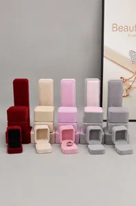 Macro view of velvet jewelry boxes in five elegant colors for rings and necklaces