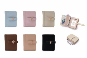 Macro view of women's short PU leather wallet with elegant leaf buckle detail