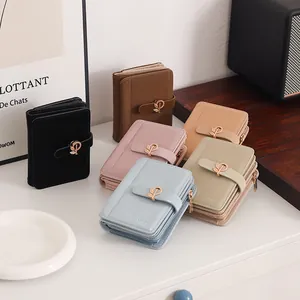 Detail shot of multi-colored women's small PU wallets featuring unique leaf gold buckles.