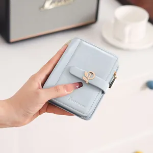 Close-up of a light blue PU leather short wallet featuring a stylish leaf buckle design