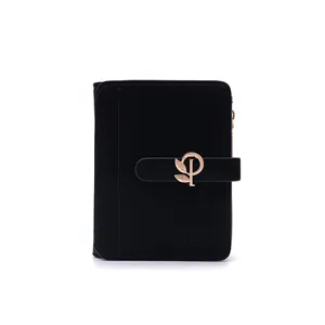 Close-up of minimalist black PU leather short wallet with golden leaf snap buckle