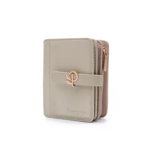 Detail of short PU leather wallet with elegant gold leaf buckle and zipper closure