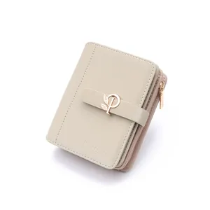 Close-up detail of a beige PU leather short wallet featuring a metal leaf buckle
