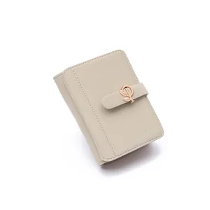 Close-up detail of a beige PU leather wallet featuring an elegant leaf-shaped metal buckle