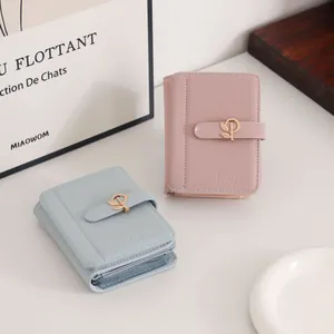 Two stylish PU leather short wallets for women featuring a leaf buckle in pink and blue.