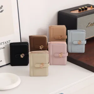 Detailed macro view of stylish PU leather short wallets featuring elegant gold leaf metal buckles
