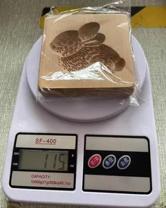 Detailansicht einer hölzernen Hasen-Keksform, die 115g auf einer Waage wiegt.