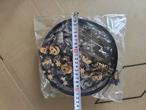 Close-up detail and size measurement of a black mesh Halloween witch hat with gold pumpkin prints