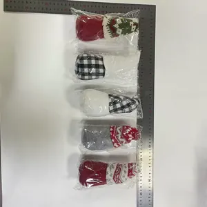 Detail showing five Christmas faceless gnomes with metal rulers for size reference