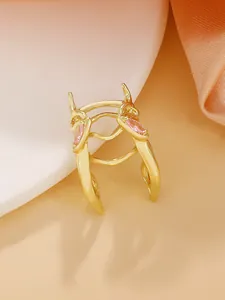 Close-up view of a gold beetle-shaped ring featuring exquisite pink marquise gemstone details